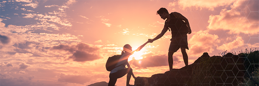 image of two individuals on a hill