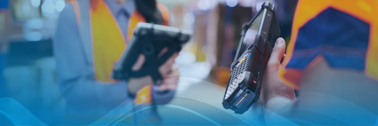 two warehouse workers using devices