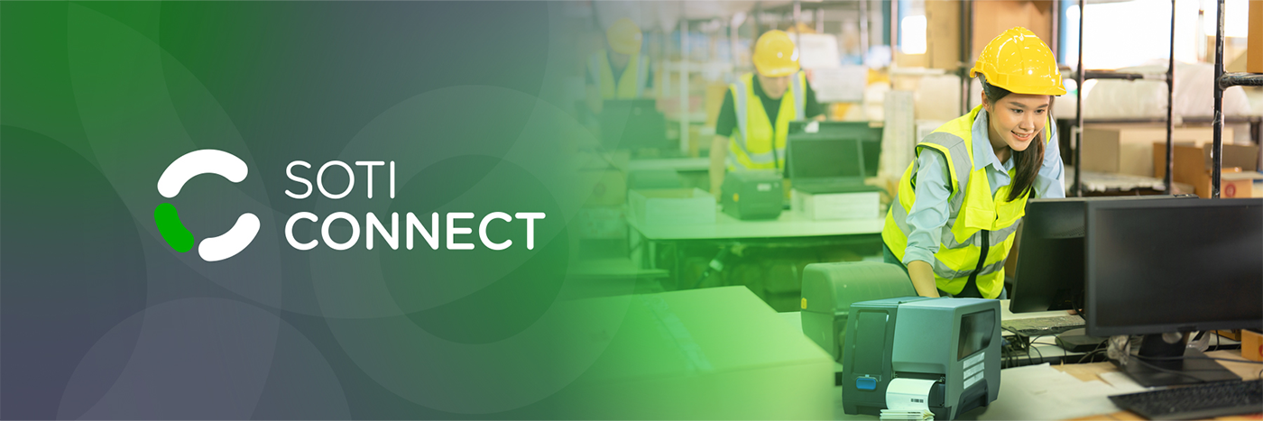 SOTI Connect | Warehouse worker using a computer and printer